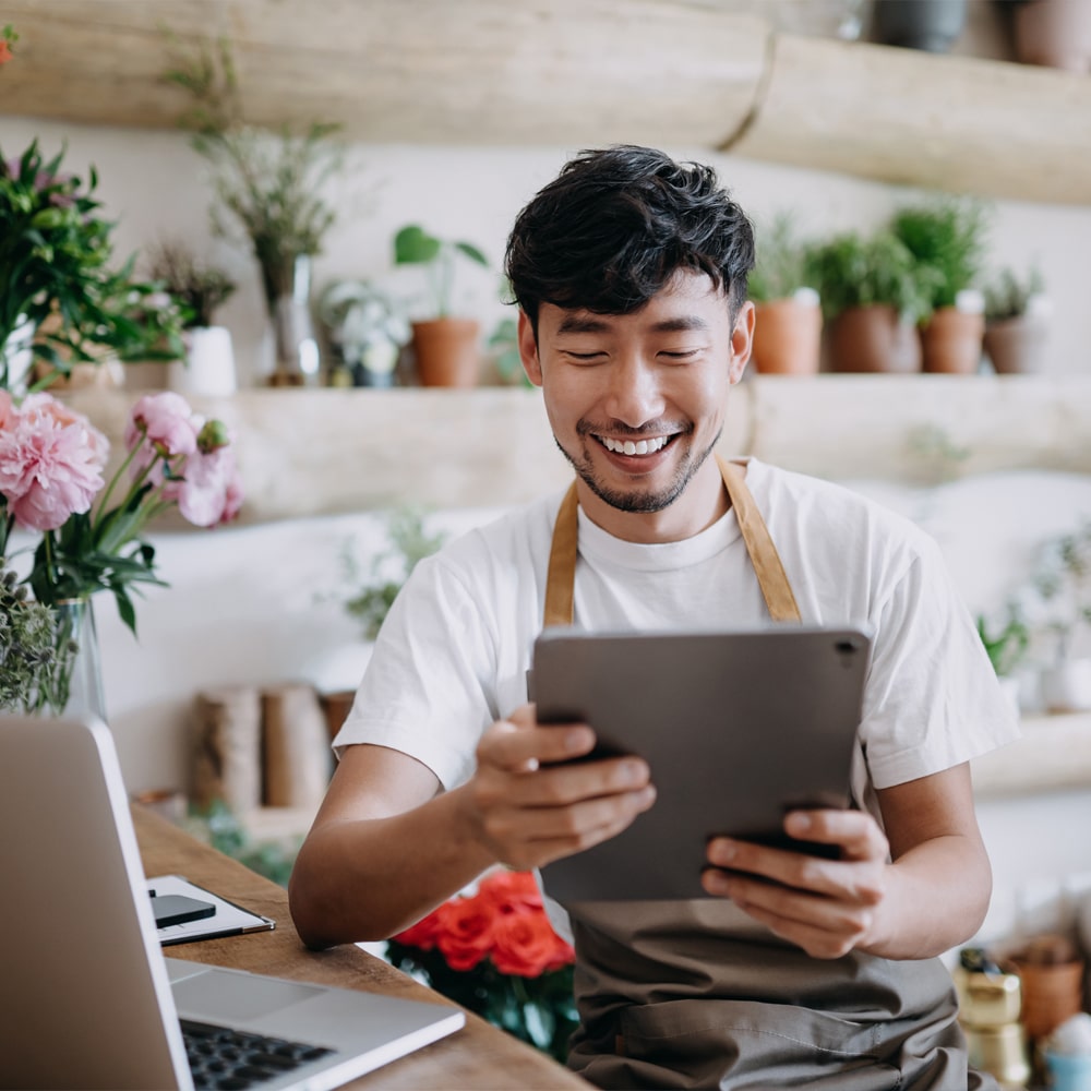 a person sitting at a table using a laptop