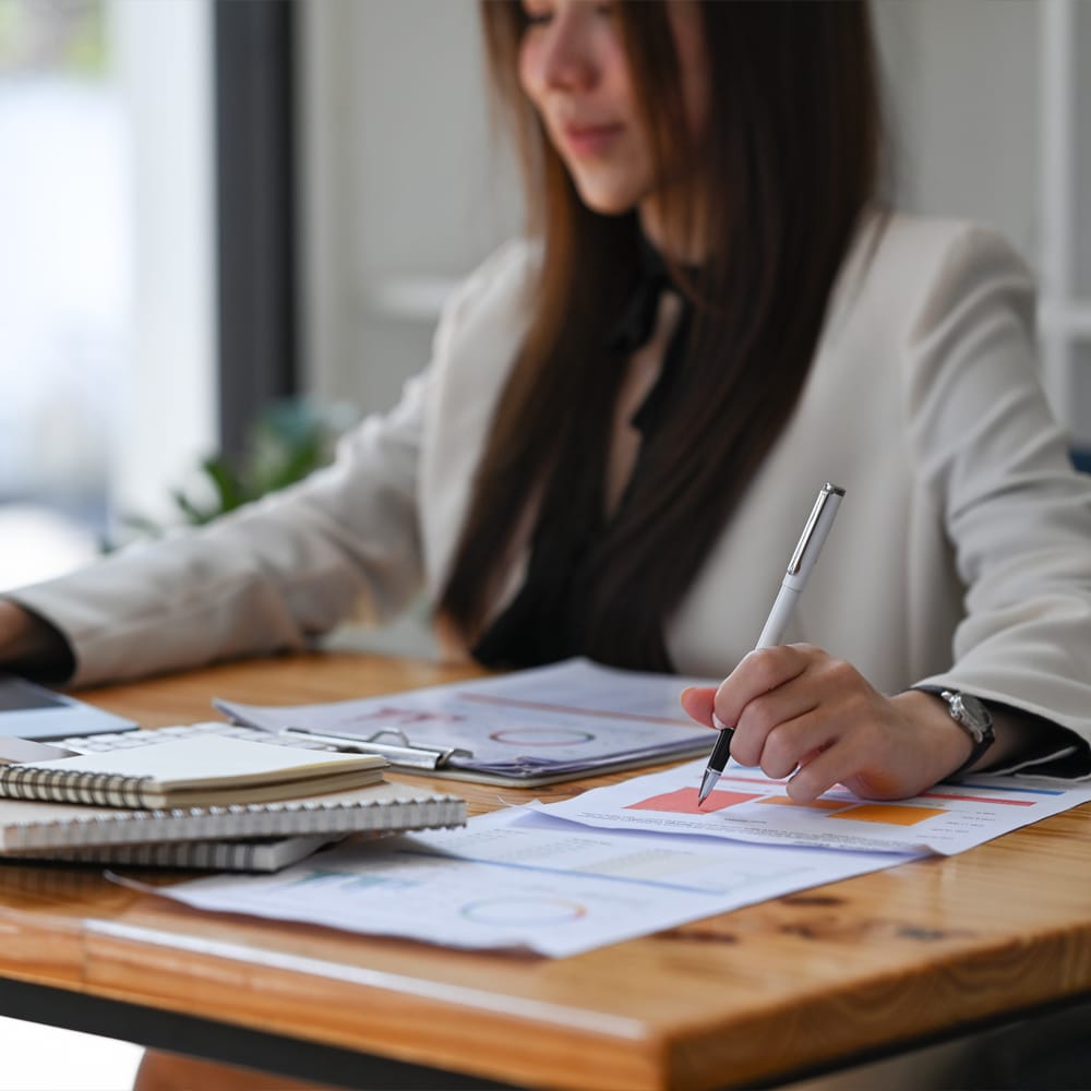 a woman sitting at a table using a laptop