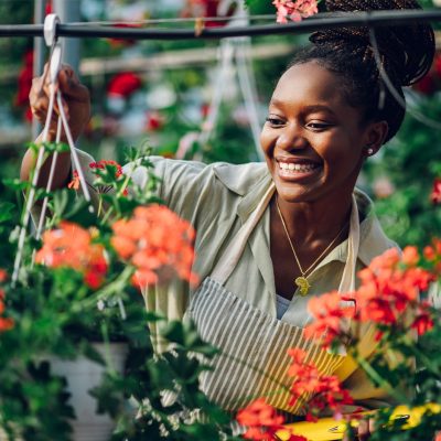 A Woman Standing In Front Of A Flower