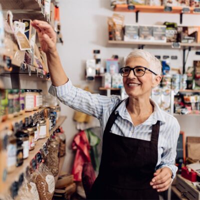 A Elder Standing In Front Of A Shop