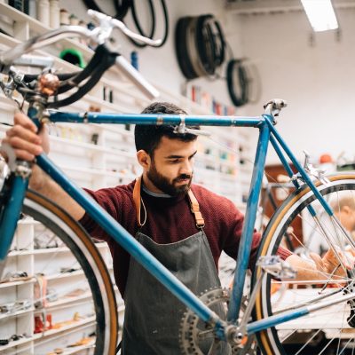 Picture Of A Man Fixing His Bicycle